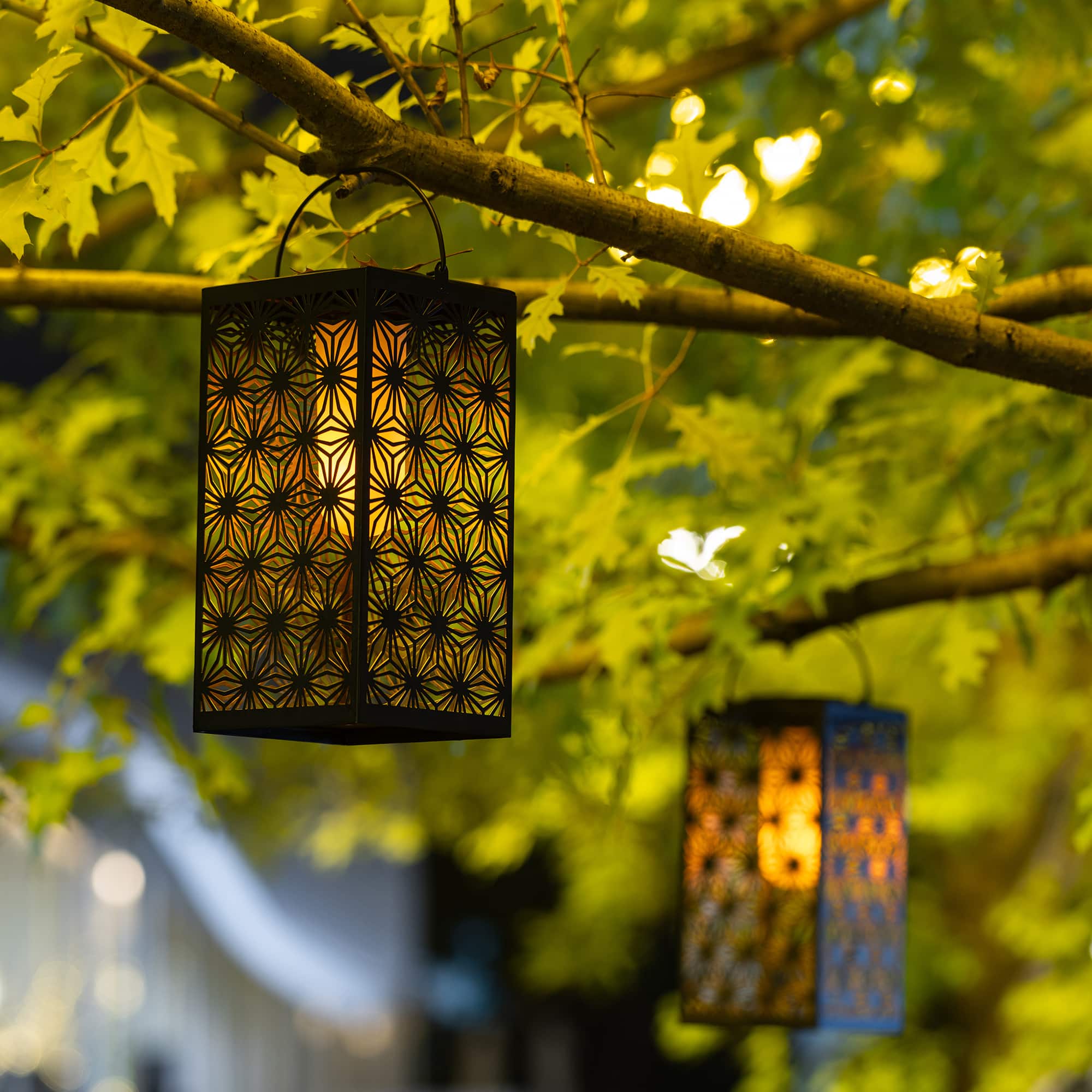 Glitzhome® 11" Set of 2 LED Black Metal Cutout Pattern Solar Powered Hanging Lantern
